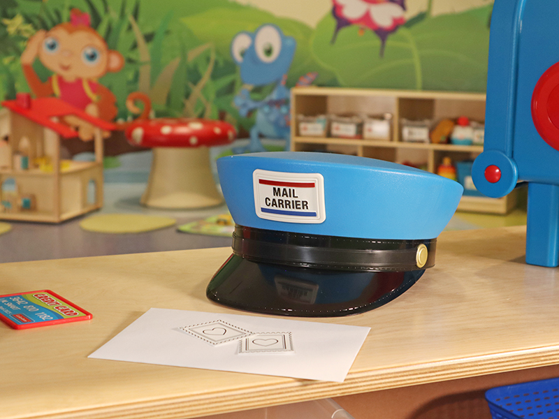 Toy mail carrier hat on a counter for playing dress up